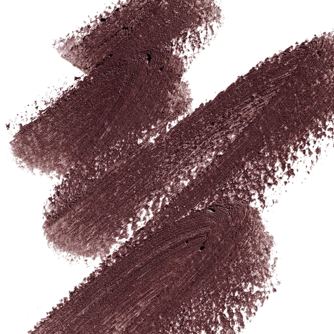 A scribble of Manasi 7 Eye and Lip Definer Yubari Success drawn on a table showing the smooth texture and brown mauve color.