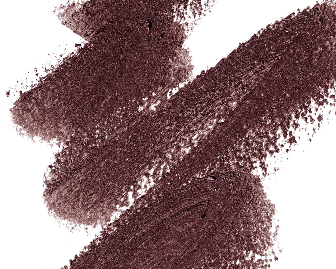 A scribble of Manasi 7 Eye and Lip Definer Yubari Success drawn on a table showing the smooth texture and brown mauve color.