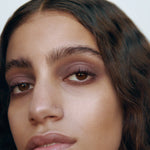 Close-up of a woman with medium complexion wearing Manasi 7 Lip and Eye Definer Yubari on her lips and eyes.