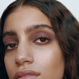Close-up of a woman with medium complexion wearing Manasi 7 Lip and Eye Definer Yubari on her lips and eyes.