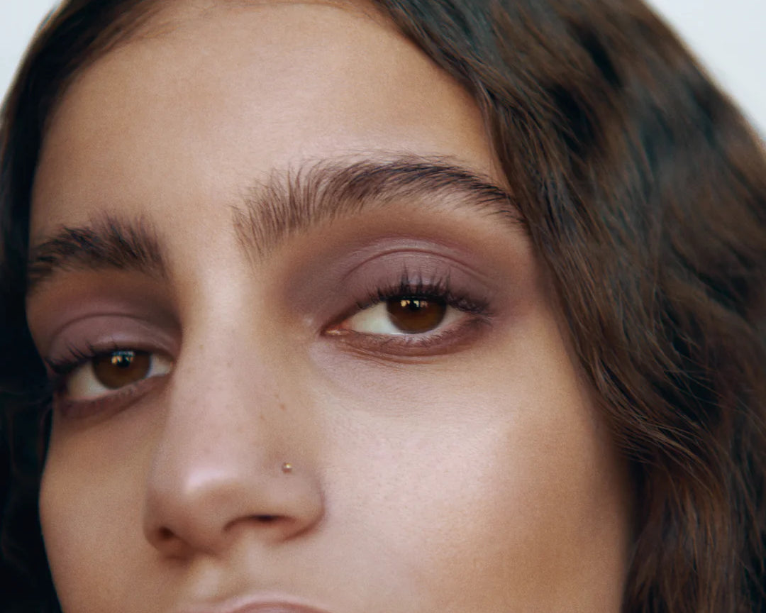 Close-up of a woman with medium complexion wearing Manasi 7 Lip and Eye Definer Yubari on her lips and eyes.
