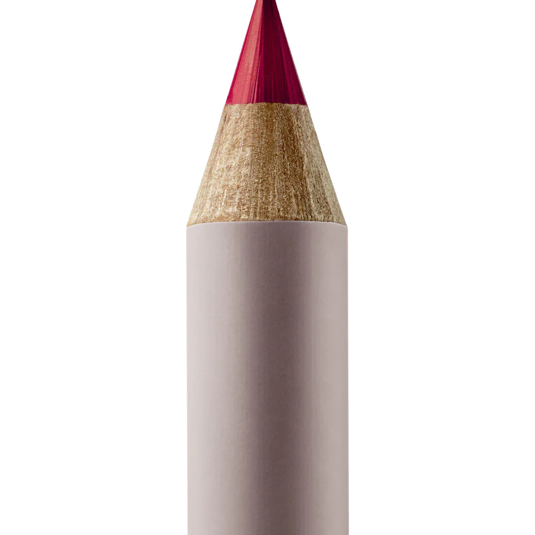 A sharpened Manasi 7 Lip and Eye Definer Castel pencil showing the deep berry color. The pencil itself is dark pink.