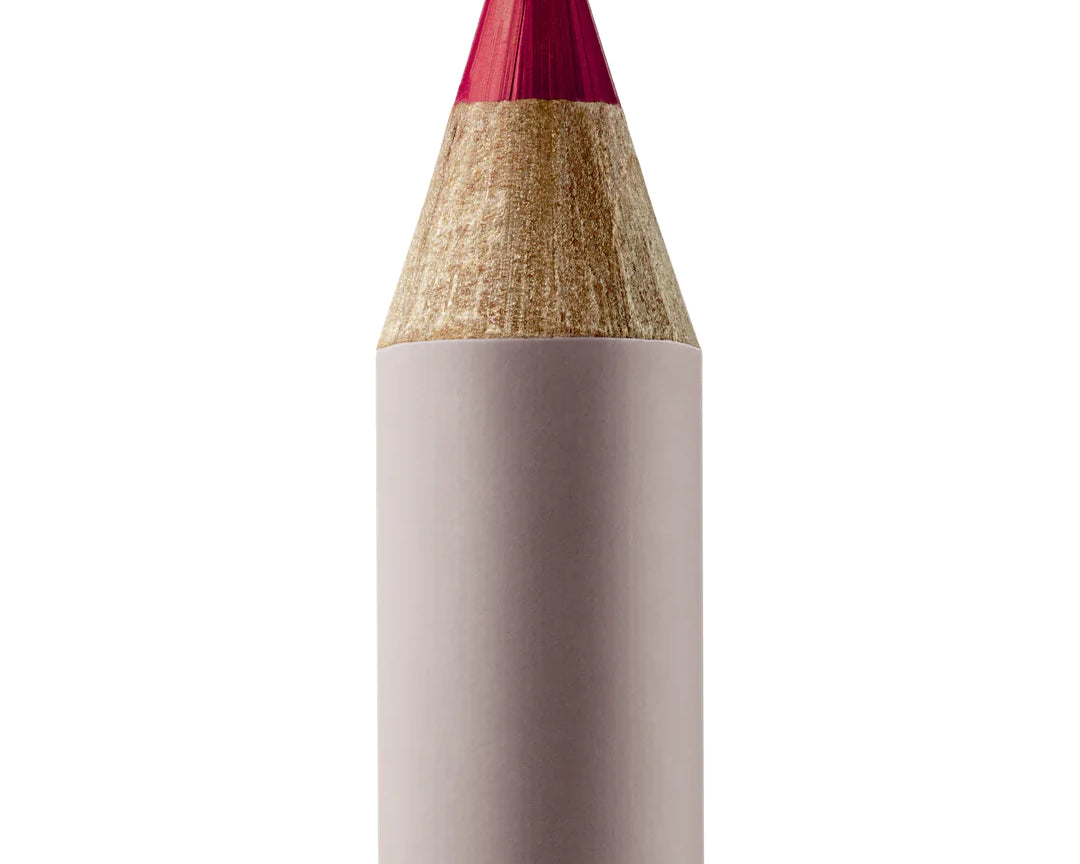 A sharpened Manasi 7 Lip and Eye Definer Castel pencil showing the deep berry color. The pencil itself is dark pink.