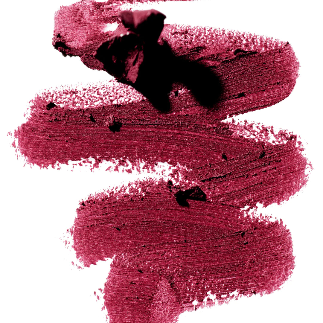 A scribble of Manasi 7 Lip and Eye Definer Castel drawn on a table showing the smooth texture and deep berry color.