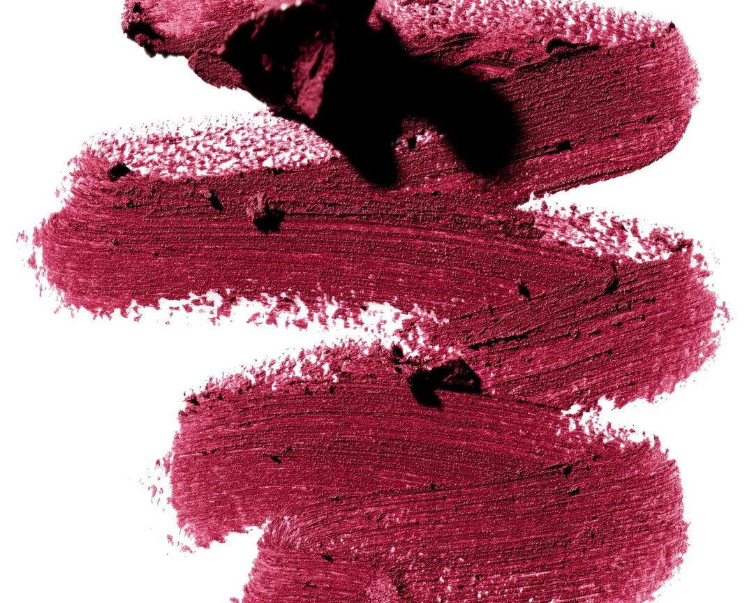 A scribble of Manasi 7 Lip and Eye Definer Castel drawn on a table showing the smooth texture and deep berry color.