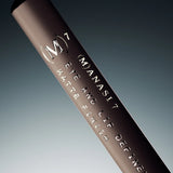 Manasi 7 Lip and Eye Definer Petunia is a dark pink pencil with metallic gold branding text and a press-on top.