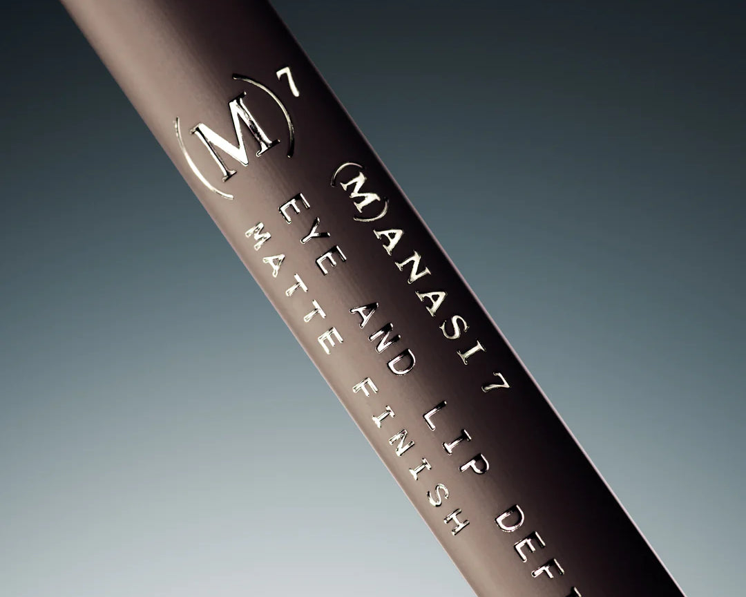 Manasi 7 Lip and Eye Definer Petunia is a dark pink pencil with metallic gold branding text and a press-on top.