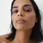 Manasi 7 All Over Colour dianthus on a woman with medium complexion's lips, cheeks, and eyes.