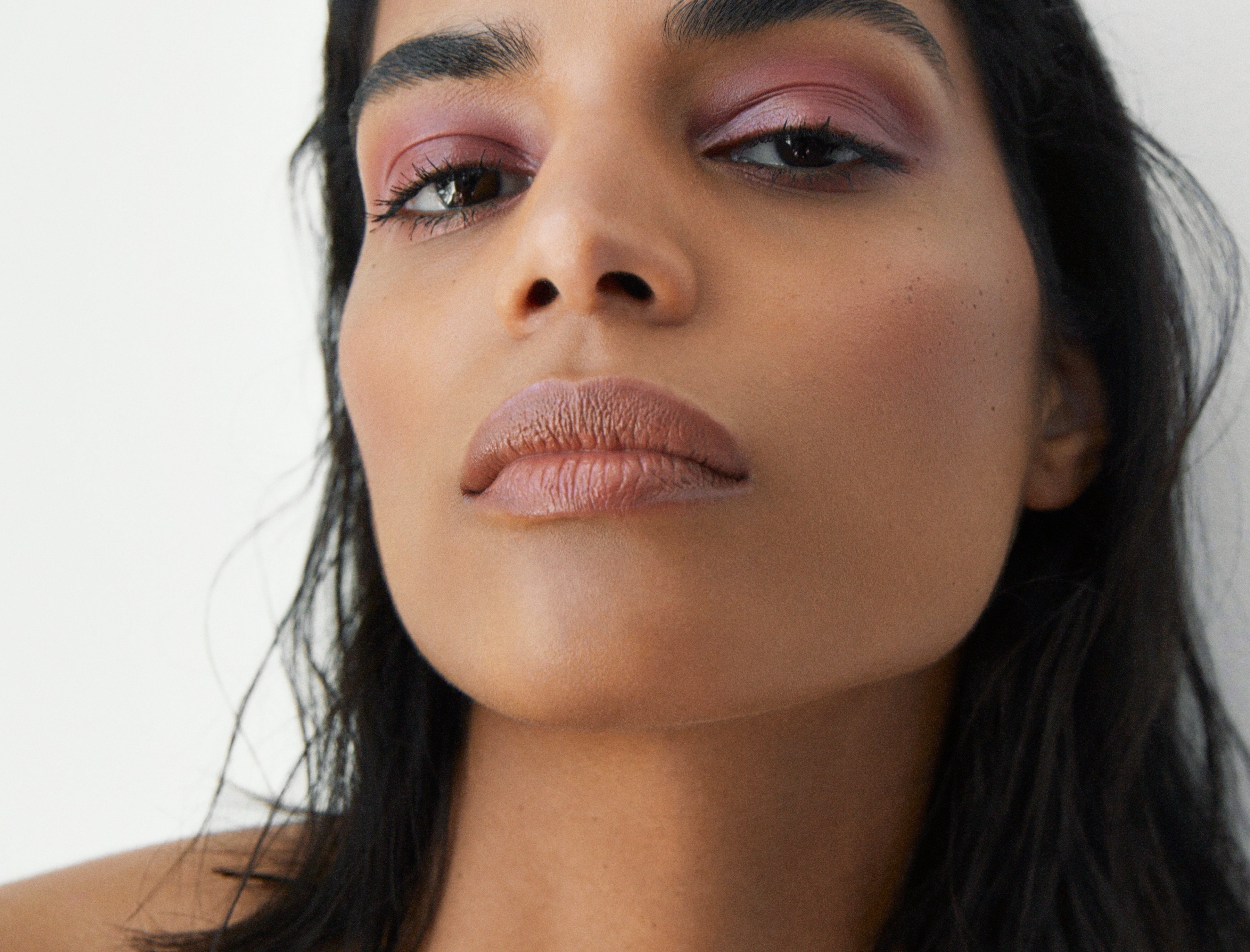 Manasi 7 All Over Colour dianthus on a woman with medium complexion's lips, cheeks, and eyes.