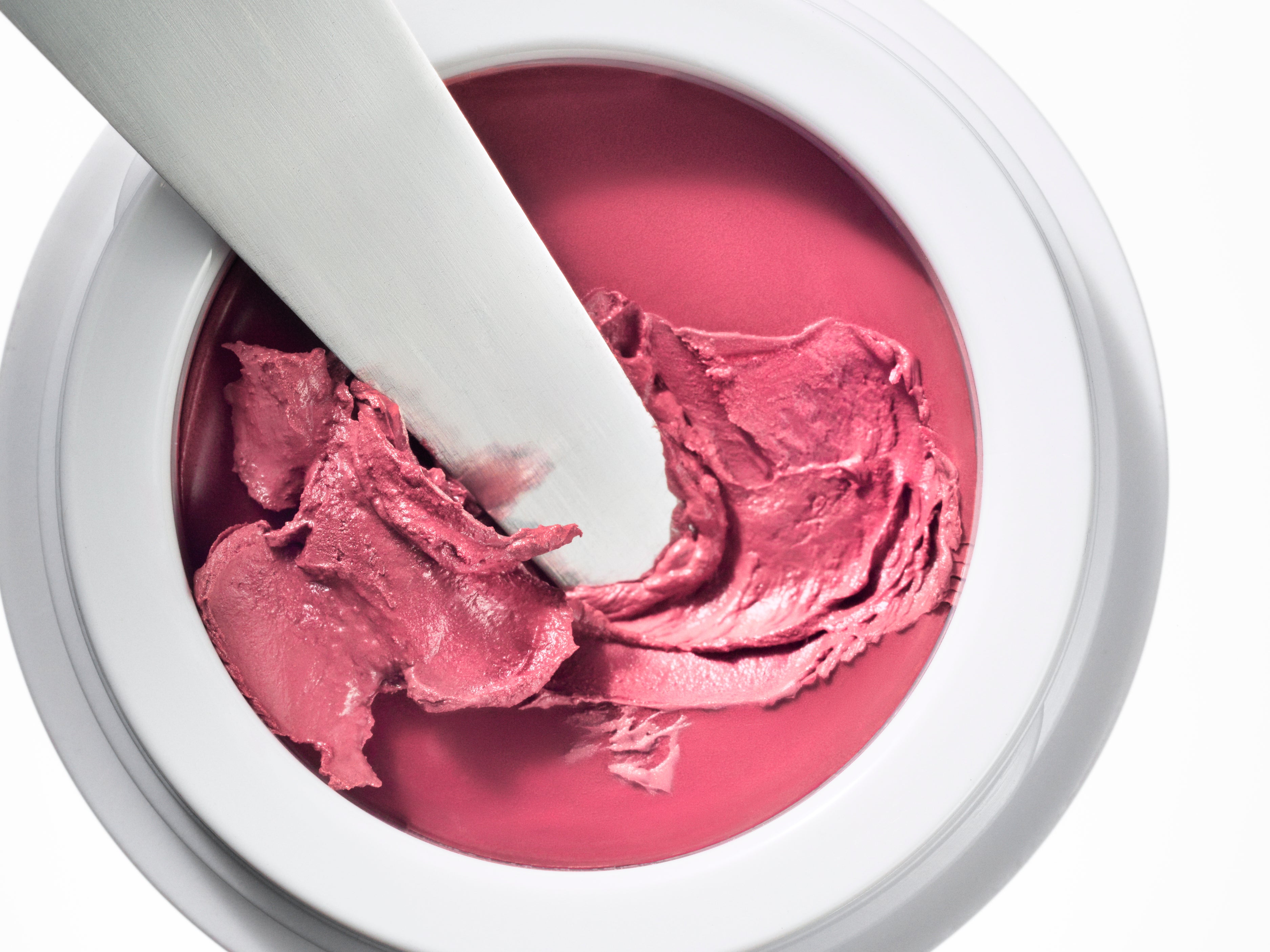 Manasi 7 All Over Colour dianthus in its white compact jar with a makeup brush dipped inside.