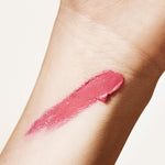 A swatch of Manasi 7 All Over Colour dianthus on a woman with light complexion's wrist showing the rose pink color.