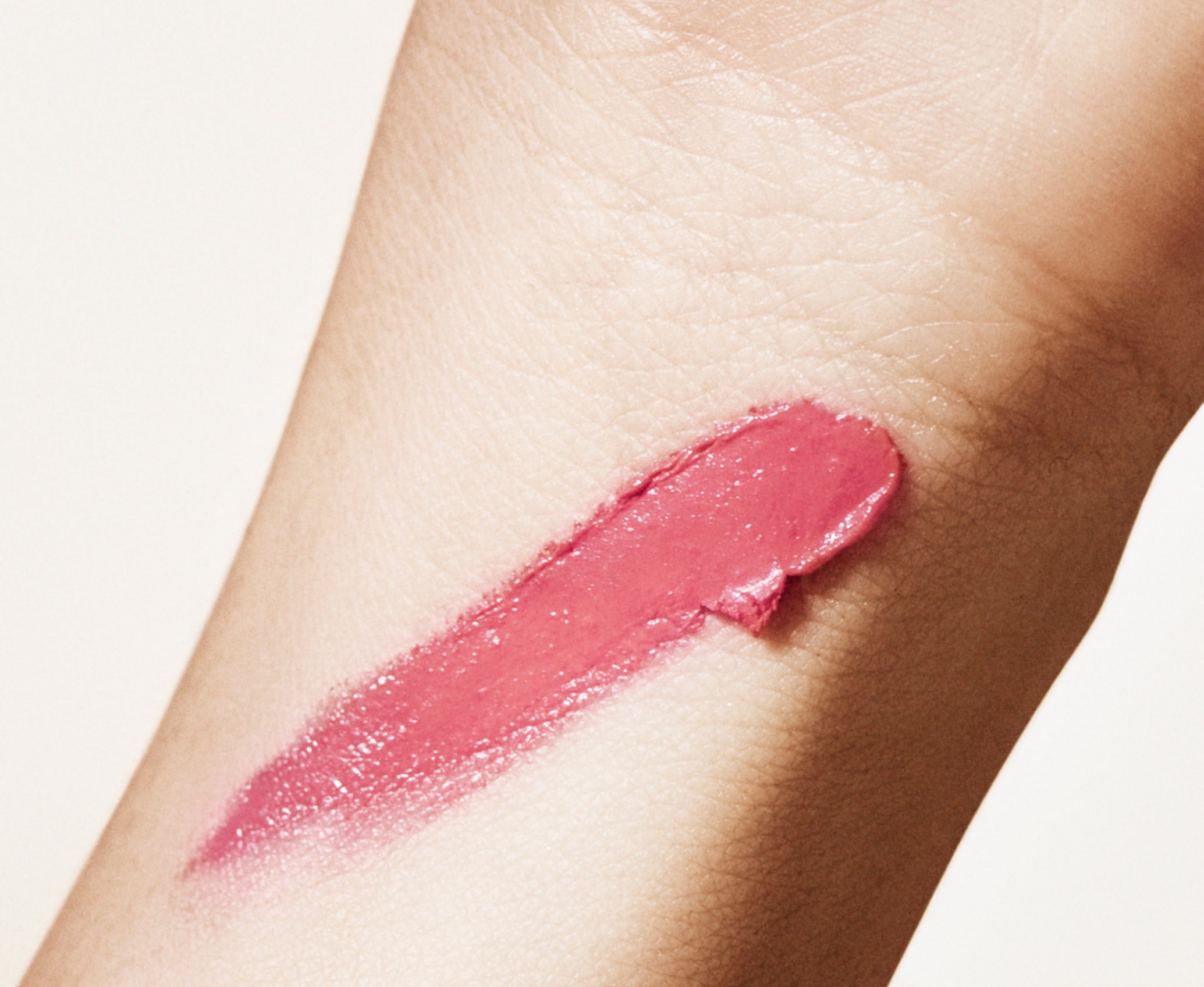 A swatch of Manasi 7 All Over Colour dianthus on a woman with light complexion's wrist showing the rose pink color.