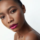 Manasi 7 All Over Colour Fuchsine on a woman with dark complexion's lips, cheeks, and eyes.