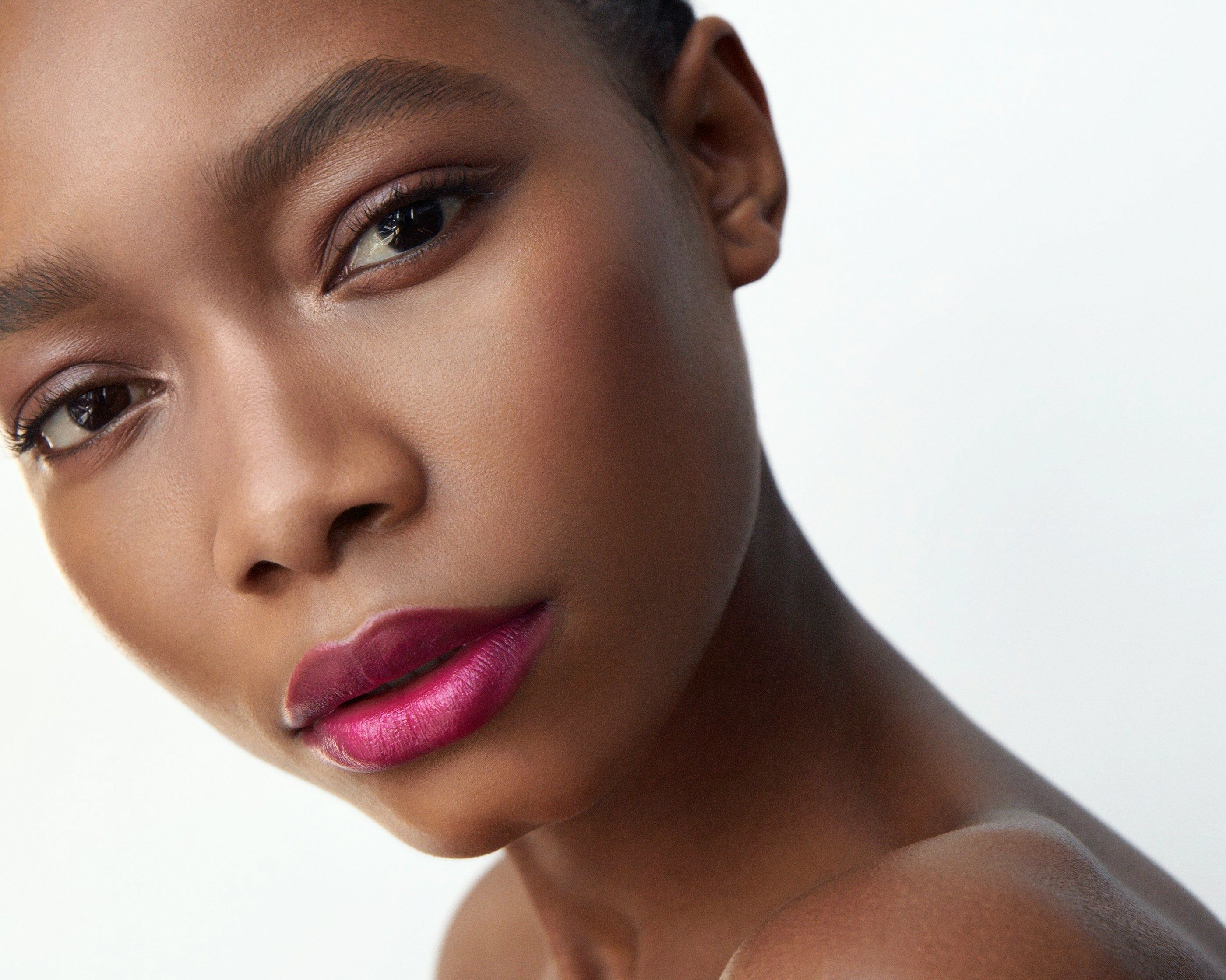 Manasi 7 All Over Colour Fuchsine on a woman with dark complexion's lips, cheeks, and eyes.