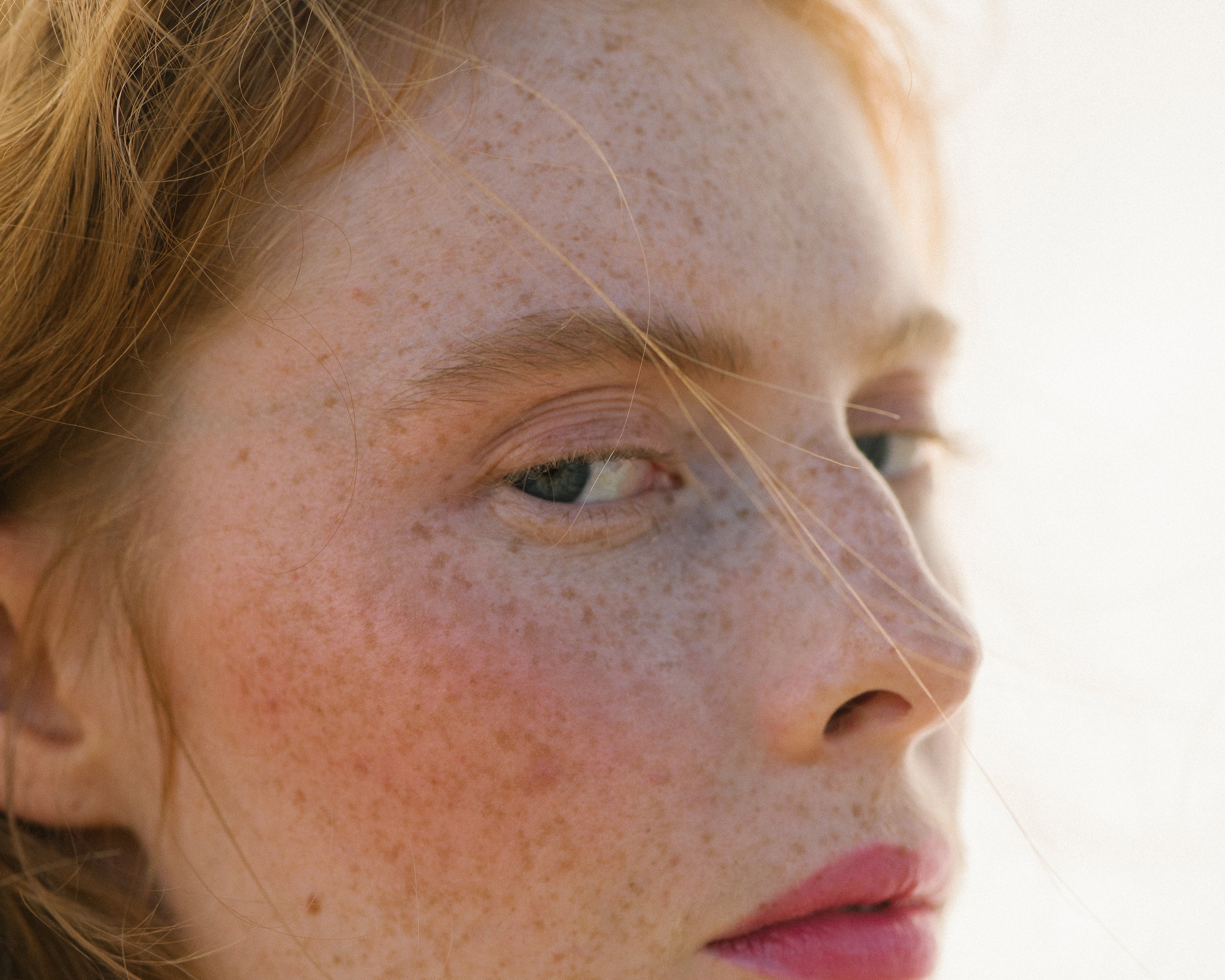 Side profile of a woman with light complexion wearing Manasi 7 All Over Colour Fuchsine on her lips, cheeks, and eyes.