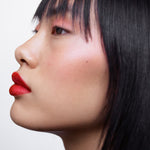Side profile of a woman with light complexion wearing Manasi 7 All Over Color Furusato on her lips, cheeks, and eyes.
