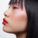 Side profile of a woman with light complexion wearing Manasi 7 All Over Color Furusato on her lips, cheeks, and eyes.