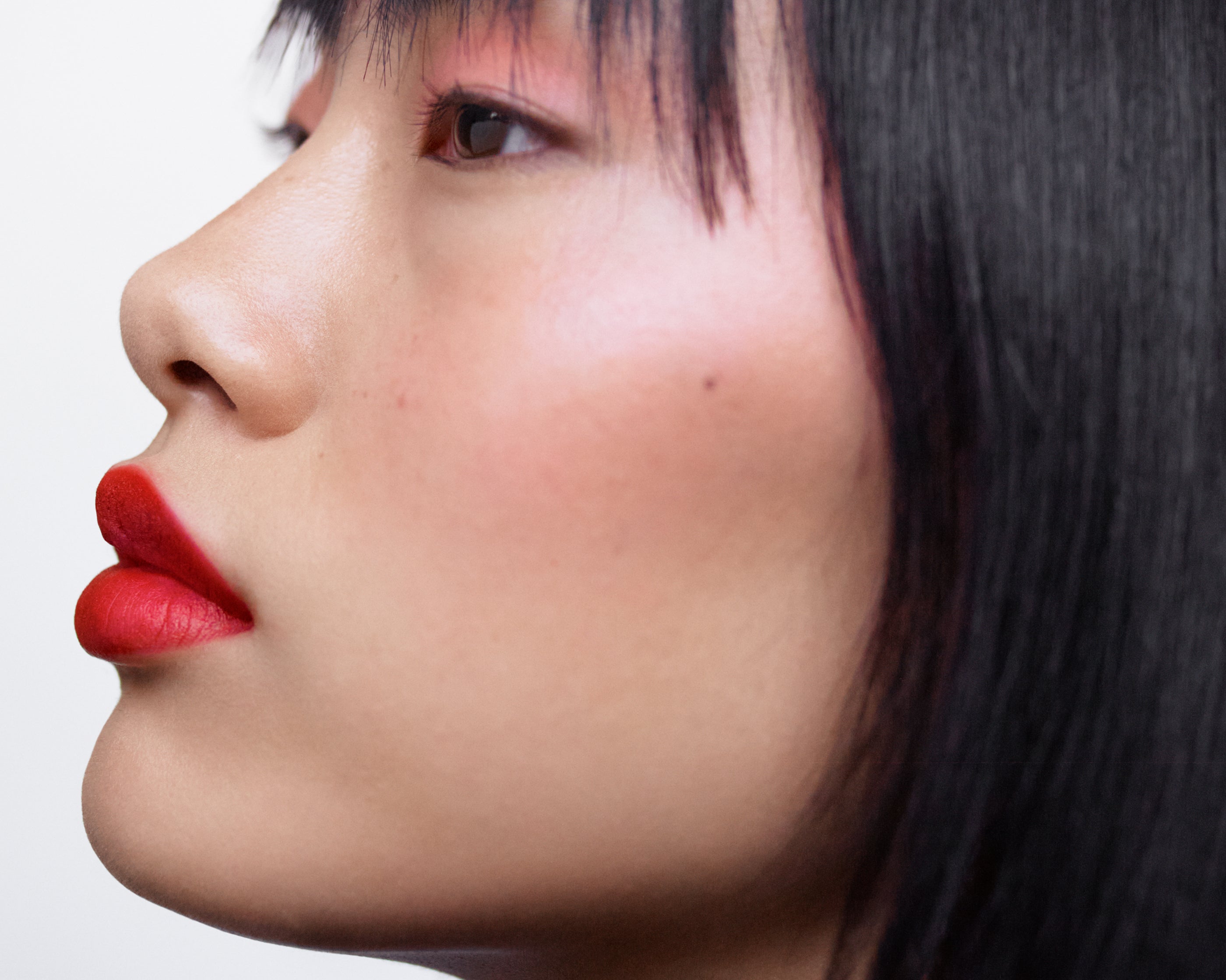 Side profile of a woman with light complexion wearing Manasi 7 All Over Color Furusato on her lips, cheeks, and eyes.