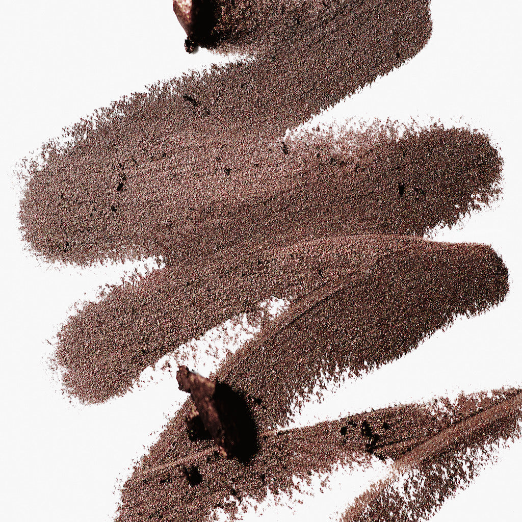 A scribble of Manasi 7 Eye and Lip Definer Nocturne drawn on a table, showing the smooth texture and bronze-brown color.