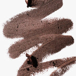 A scribble of Manasi 7 Eye and Lip Definer Nocturne drawn on a table, showing the smooth texture and bronze-brown color.
