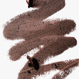 A scribble of Manasi 7 Eye and Lip Definer Nocturne drawn on a table, showing the smooth texture and bronze-brown color.