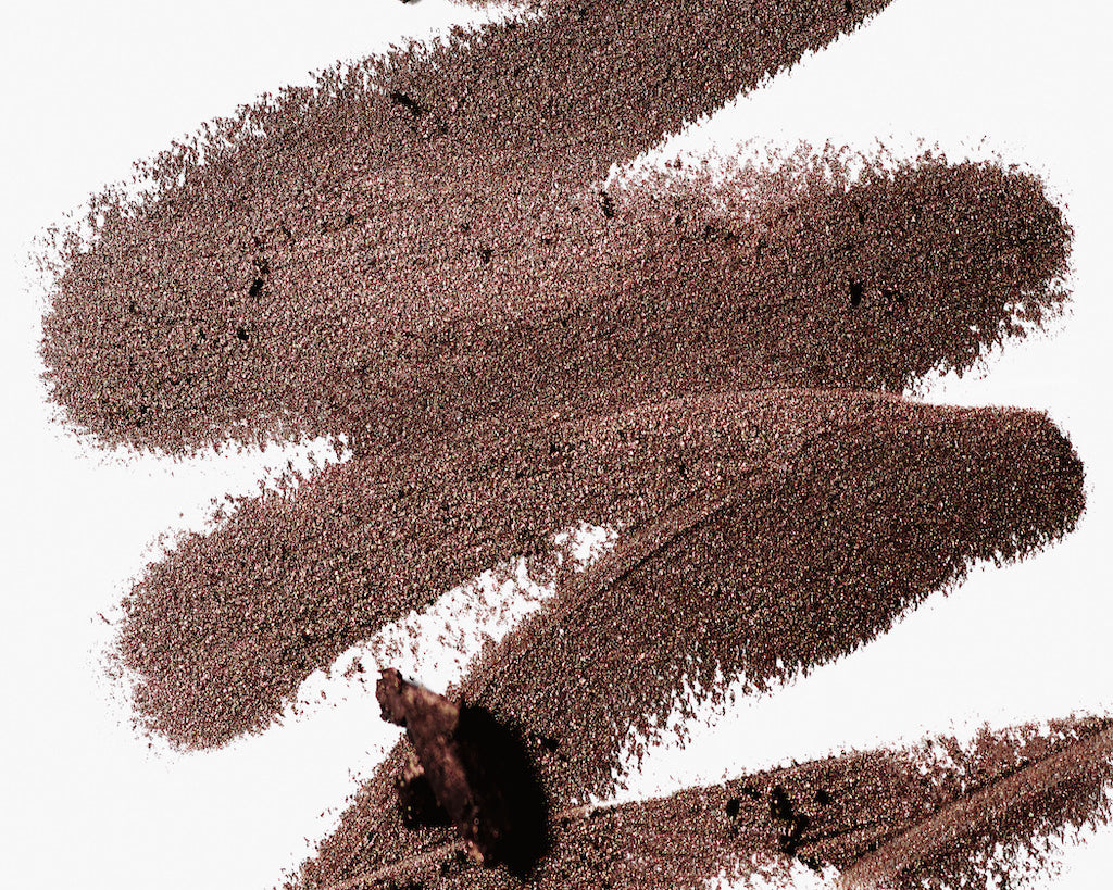 A scribble of Manasi 7 Eye and Lip Definer Nocturne drawn on a table, showing the smooth texture and bronze-brown color.