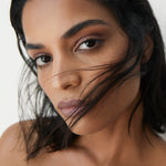 Manasi 7 All Over Colour Sisserou on a woman with medium complexion's lips, cheeks, and eyes.