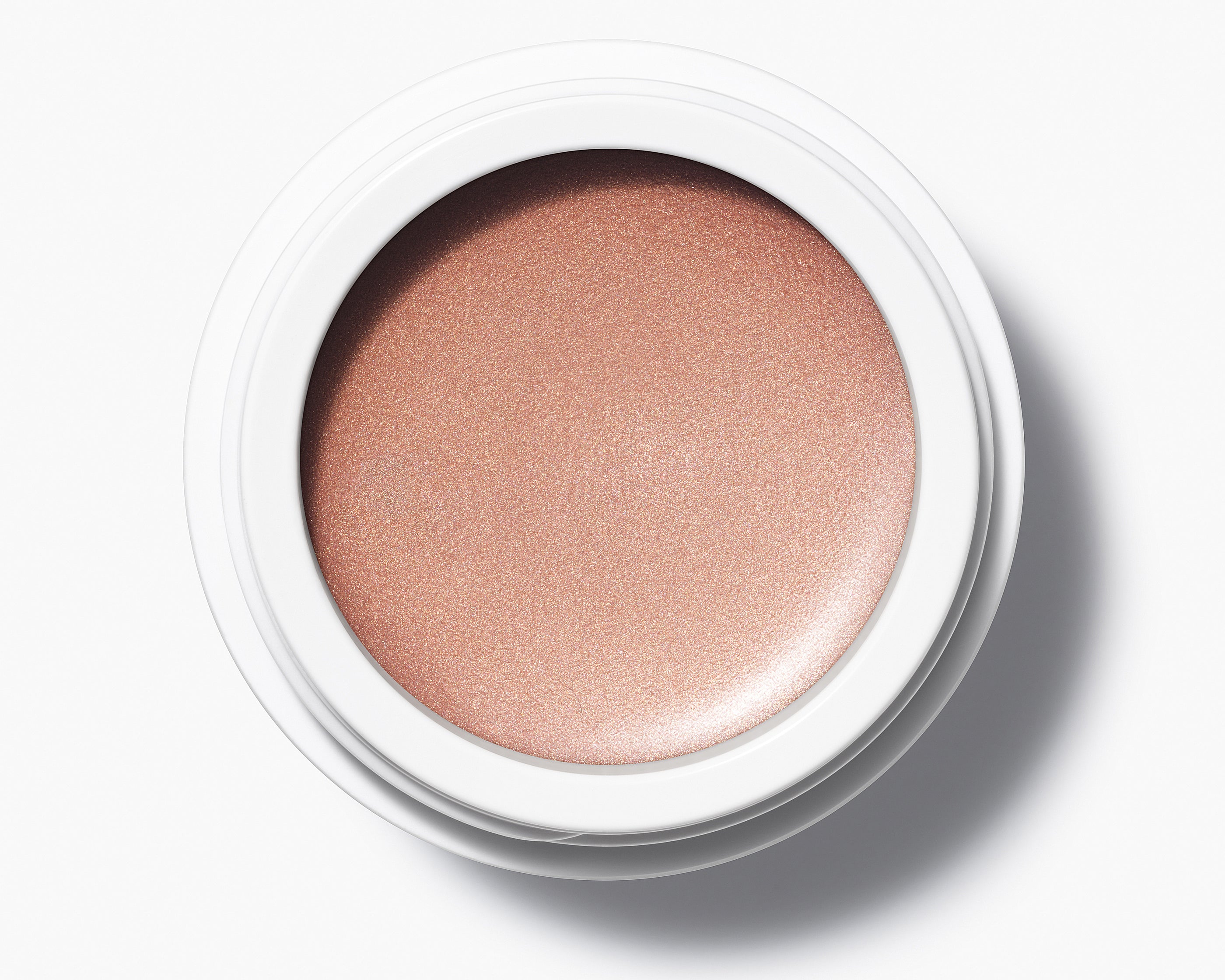 Manasi 7 Bronzelighter Roseate Radiant Finish comes in a white compact jar with its top removed, showing its vibrant color.