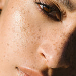 Close-up of a sunlit woman with medium complexion wearing Manasi 7 Bronzelighter Roseate.