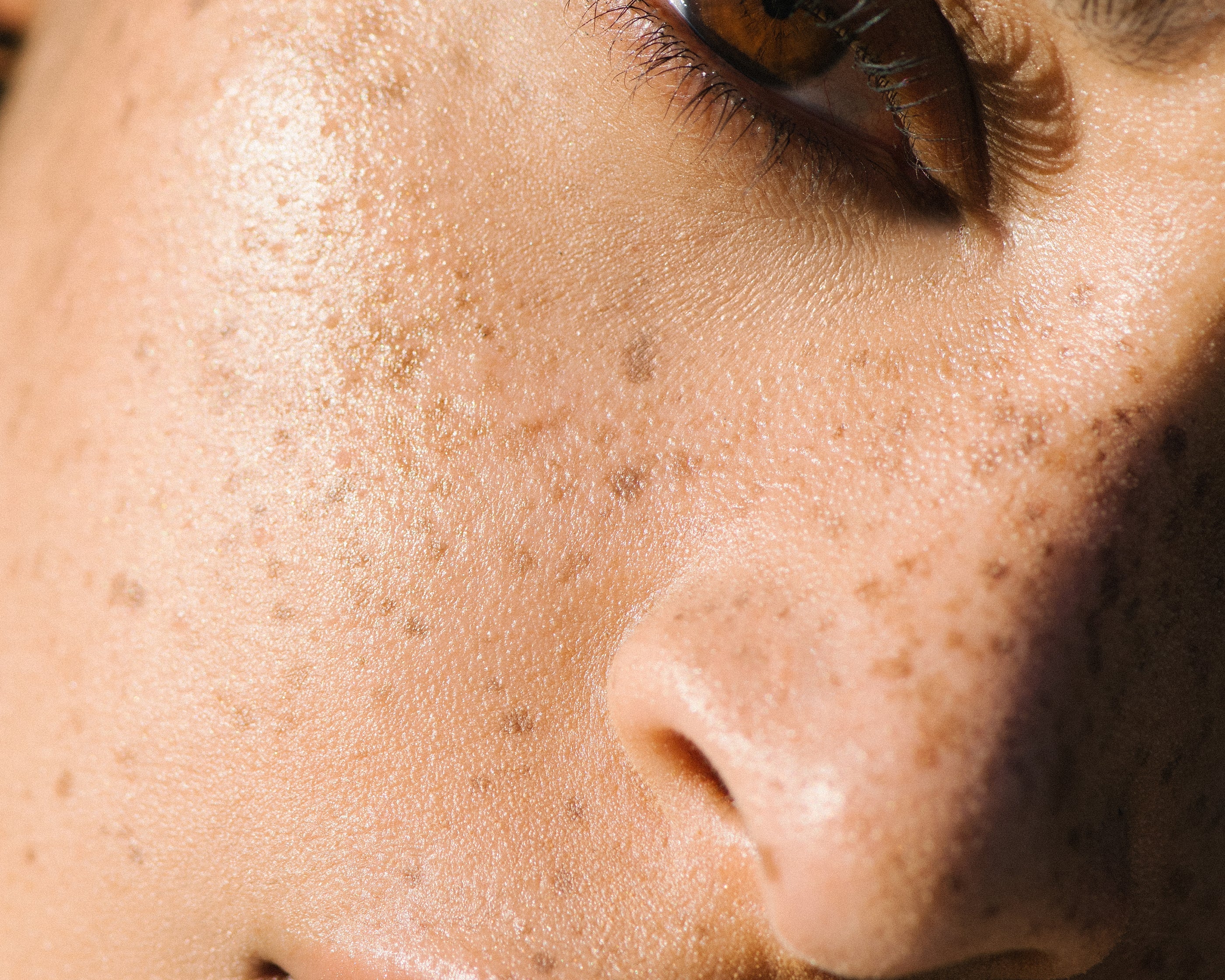 Close-up of a sunlit woman with medium complexion wearing Manasi 7 Bronzelighter Roseate.