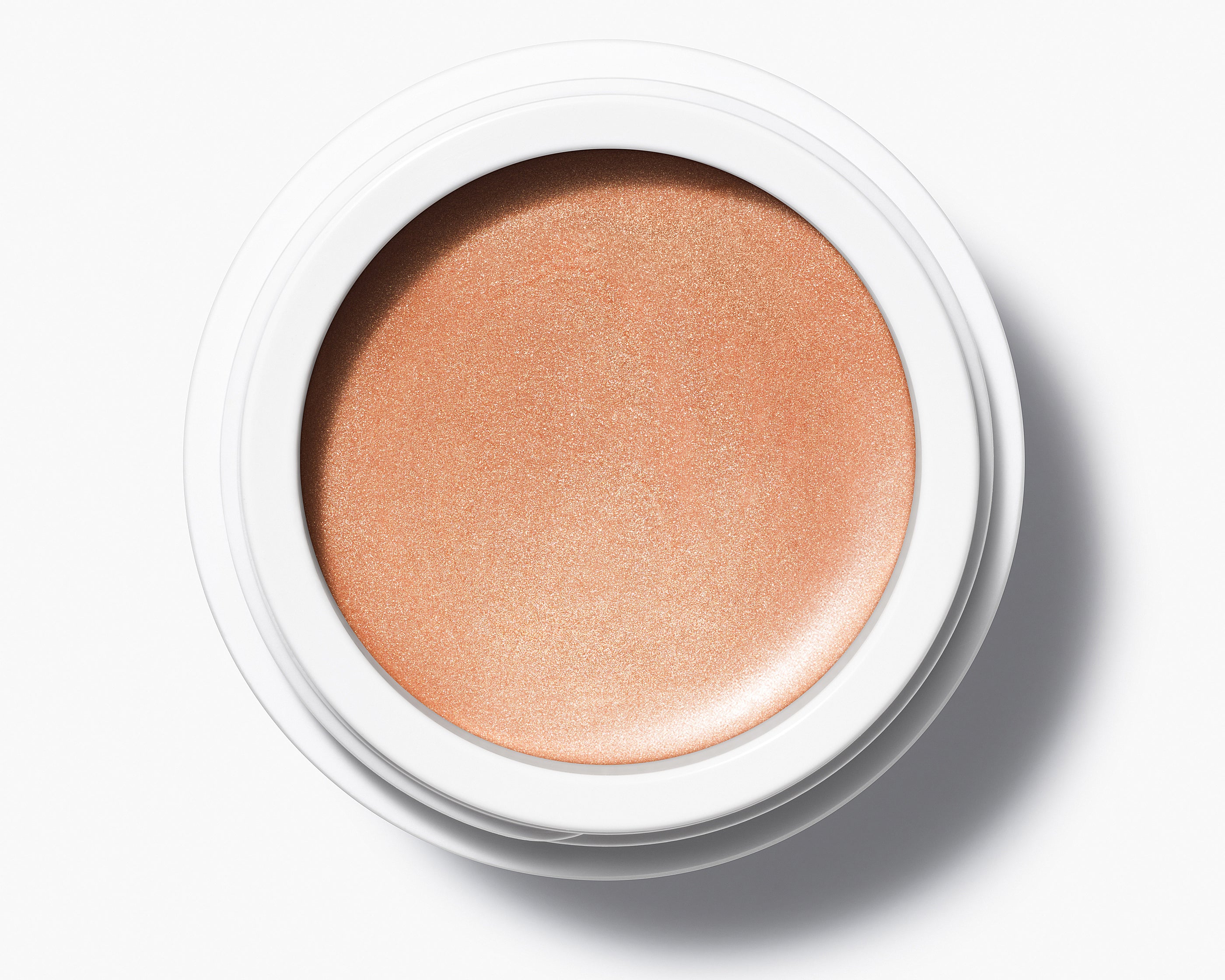 Manasi 7 Strobelighter Heliconia Radiant Finish comes in a white compact jar with its top off, showing the bronze-golden color.