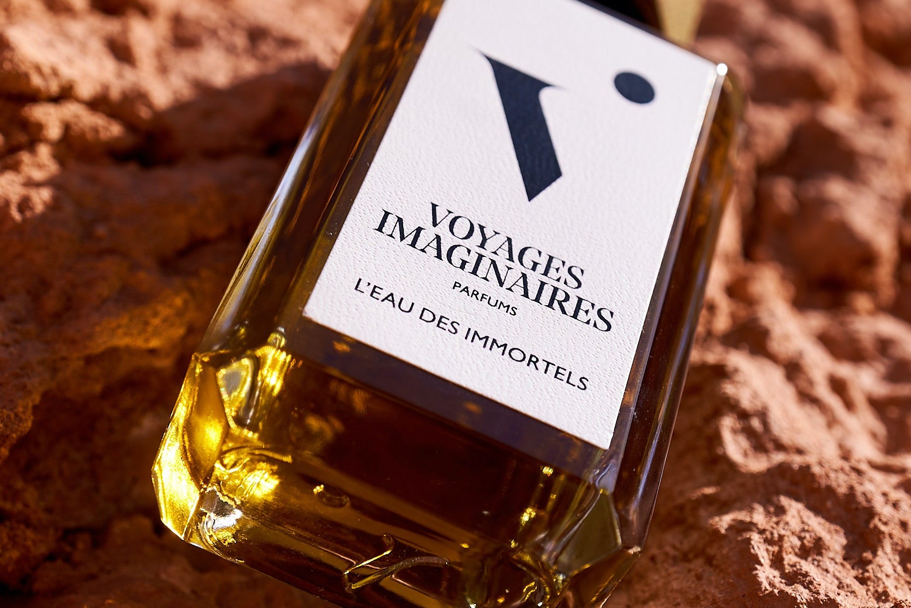 
  
  A lightly misted African Botanics Infusion Essence placed powerfully on a granite table.
  
