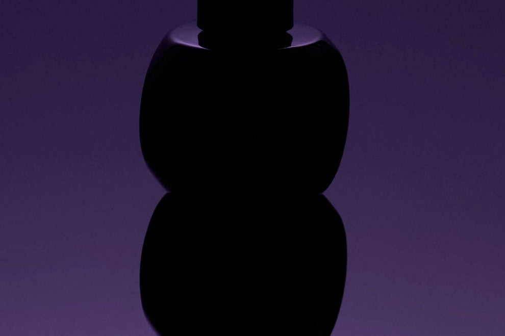 
  
  Black Osmé Fragrance Obsidian abstract  on a purple gradient background
  
