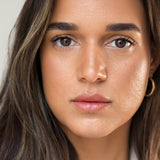 
  
  Ere Perez Oat Milk Foundation Brew on a woman with medium complexion and neutral undertones.
  
