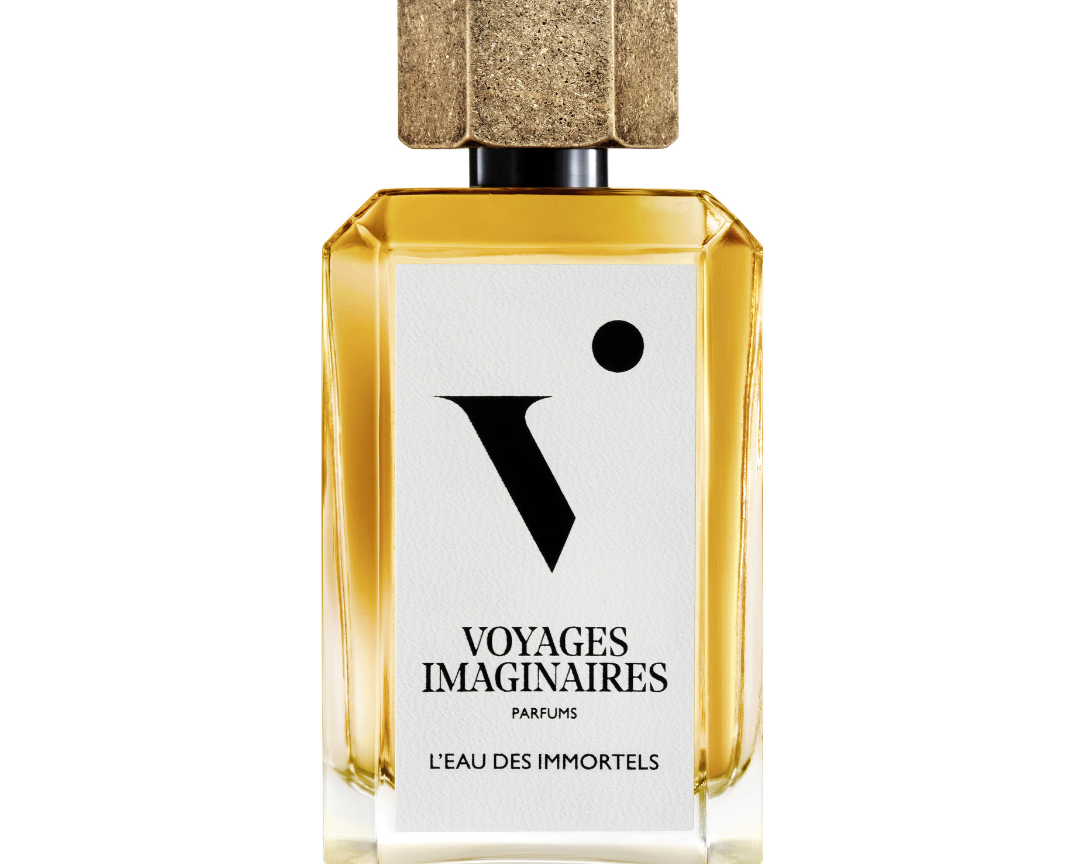 
  
  L'eau Des Immortels perfume in a geometric glass bottle with white logo sticker and textured gold magnetic cap.
  
