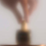 
  
  Osmé Fragrance PIRYTE showing hands placing the perfume on a counter after use.
  
