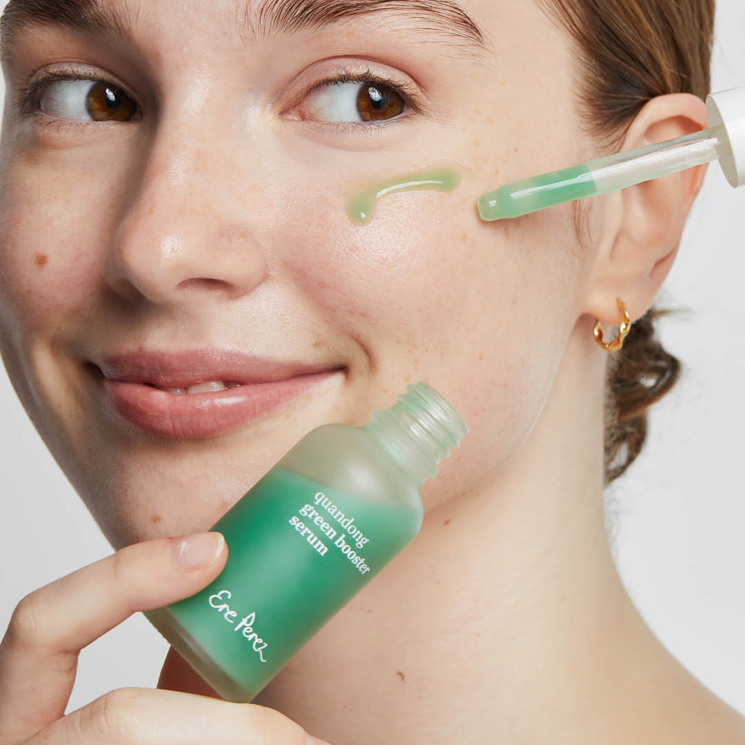 
  
  Person applying Ere Perez Quandong Green Booster Serum
  
