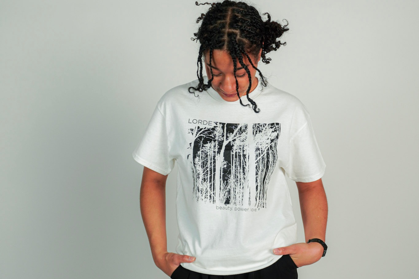 
  
  Person wearing LORDE Beauty Power Love Artist Designed Graphic T-Shirt
  
