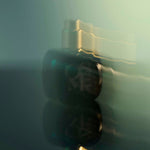 
  
  Osmé Fragrance TURMALI in blurred motion displaying gold and green reflection.
  
