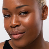 
  
  Ere Perez Oat Milk Foundation Mocha on a woman with dark complexion and neutral undertones.
  
