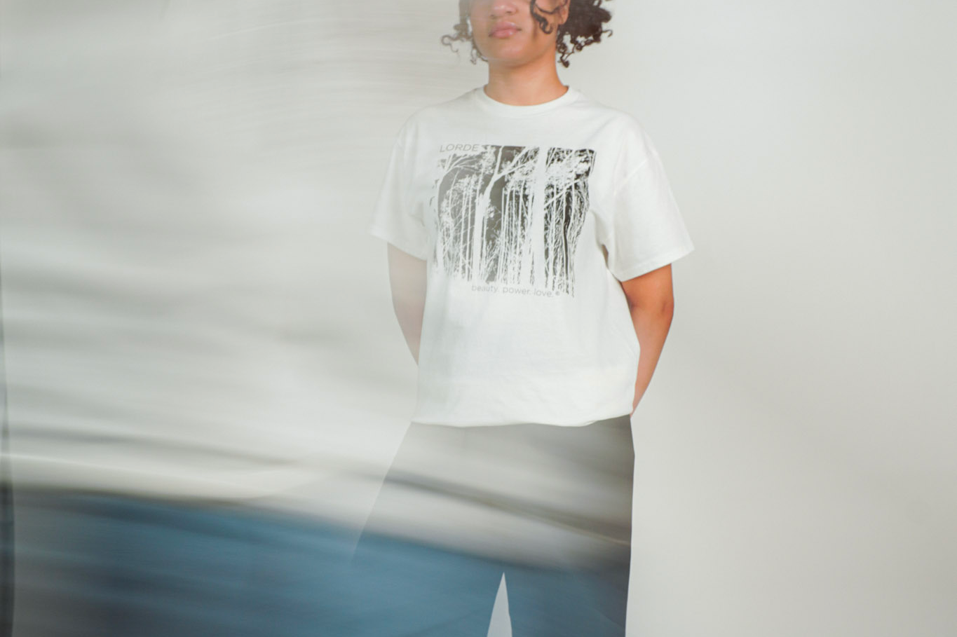 
  
  Person wearing LORDE Beauty Power Love Artist Designed Graphic T-Shirt
  
