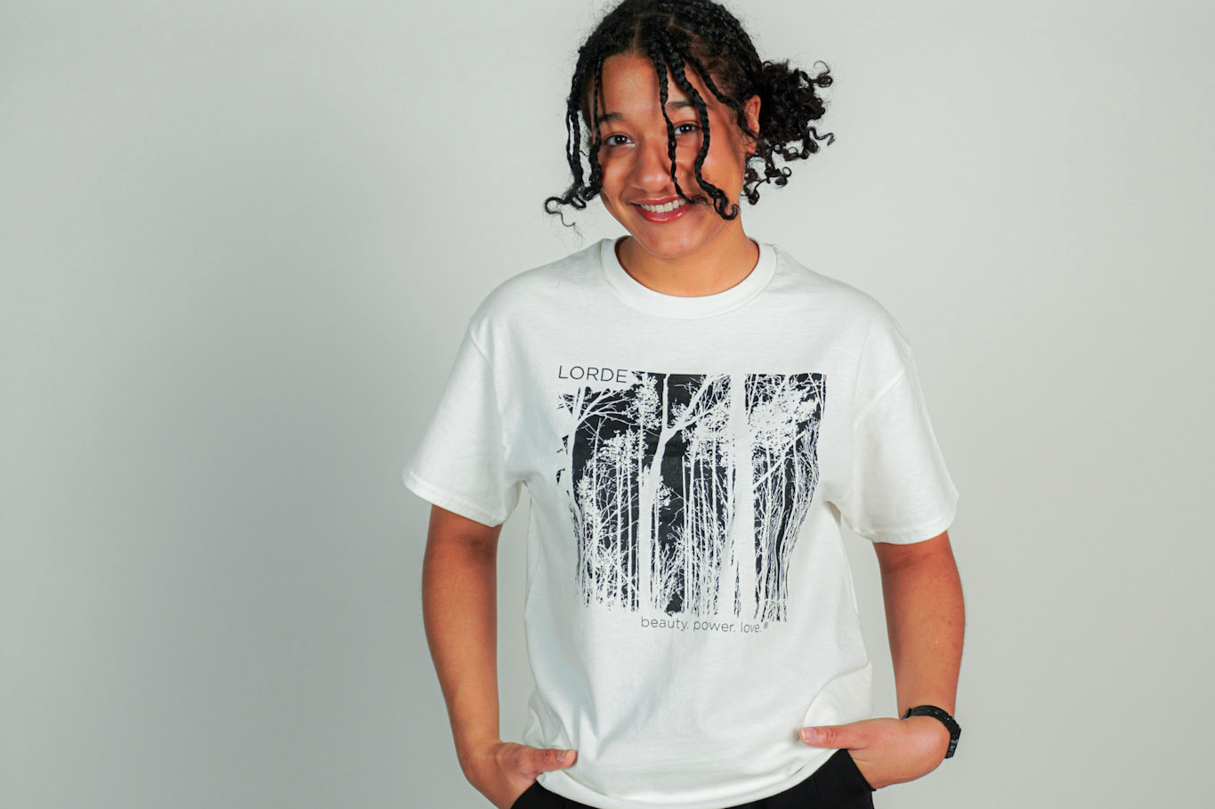 
  
  Person wearing LORDE Beauty Power Love Artist Designed Graphic T-Shirt
  
