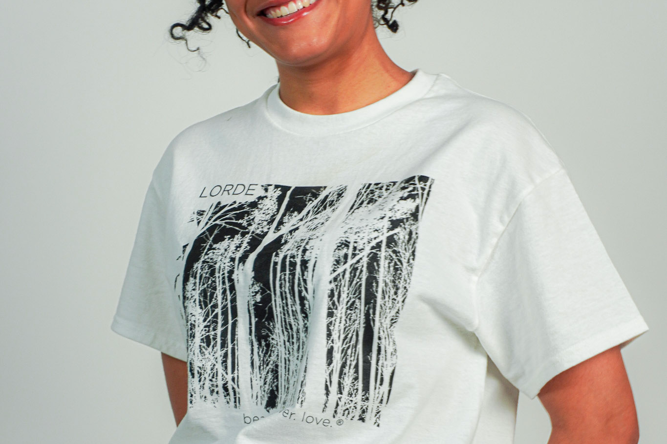 
  
  Person wearing LORDE Beauty Power Love Artist Designed Graphic T-Shirt
  
