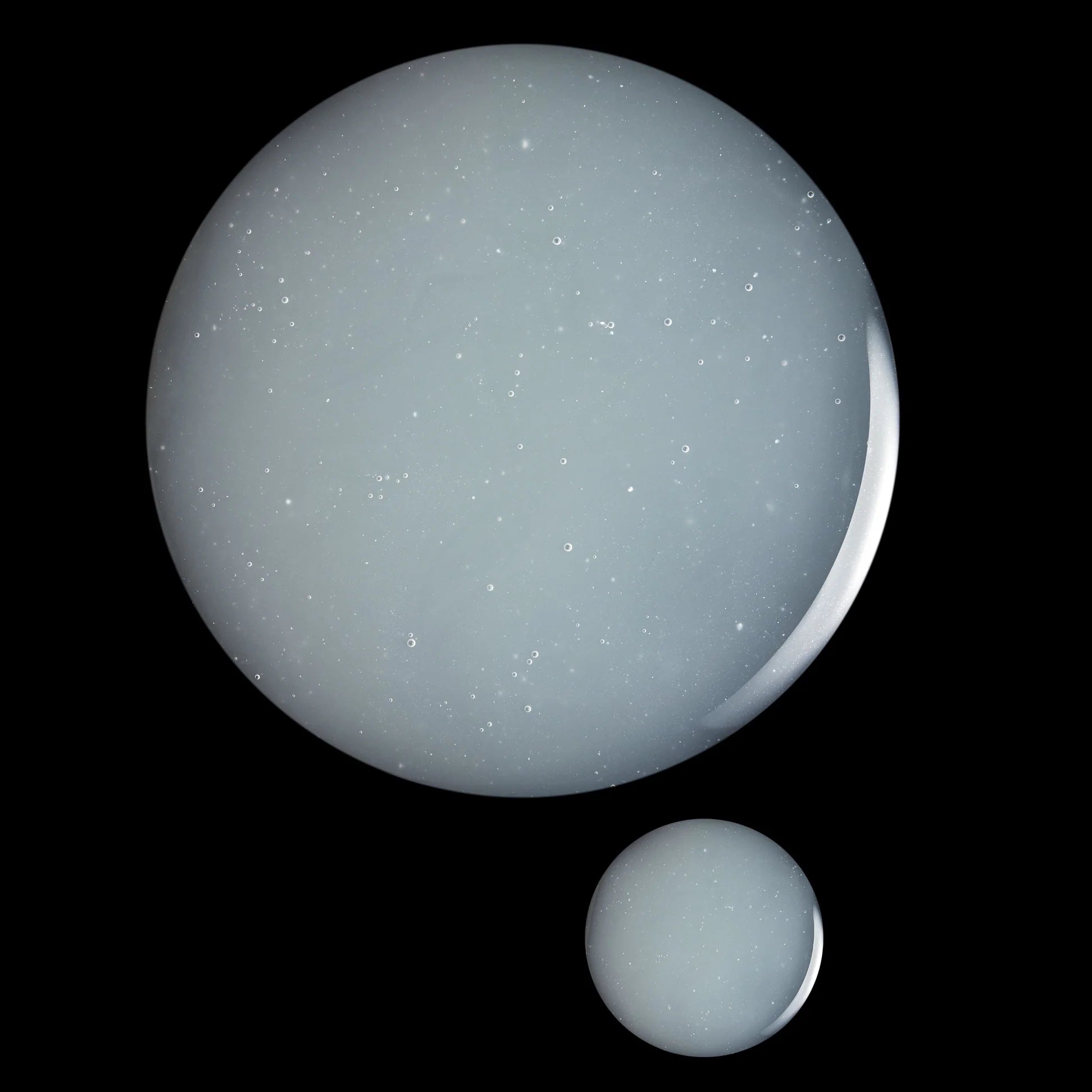 
  
  Close-up droplets of Omorovicza Blue Diamond Concentrate show its soft blue color and a light, creamy consistency.
  
