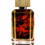
  
  perfume bottle showing its liquid with red floral backdrop behind the logo sticker.
  
