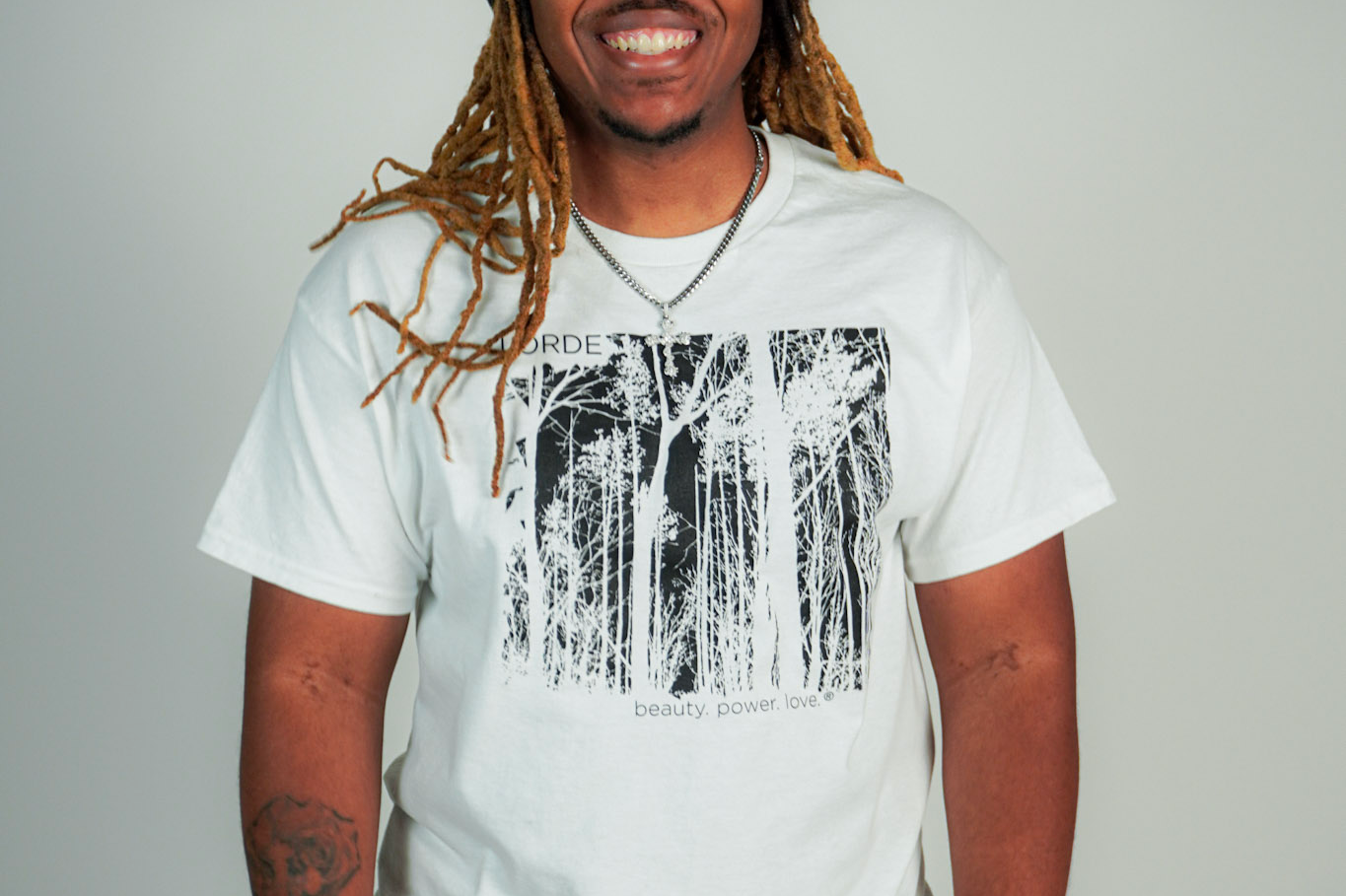 
  
  Person wearing LORDE Beauty Power Love Artist Designed Graphic T-Shirt
  
