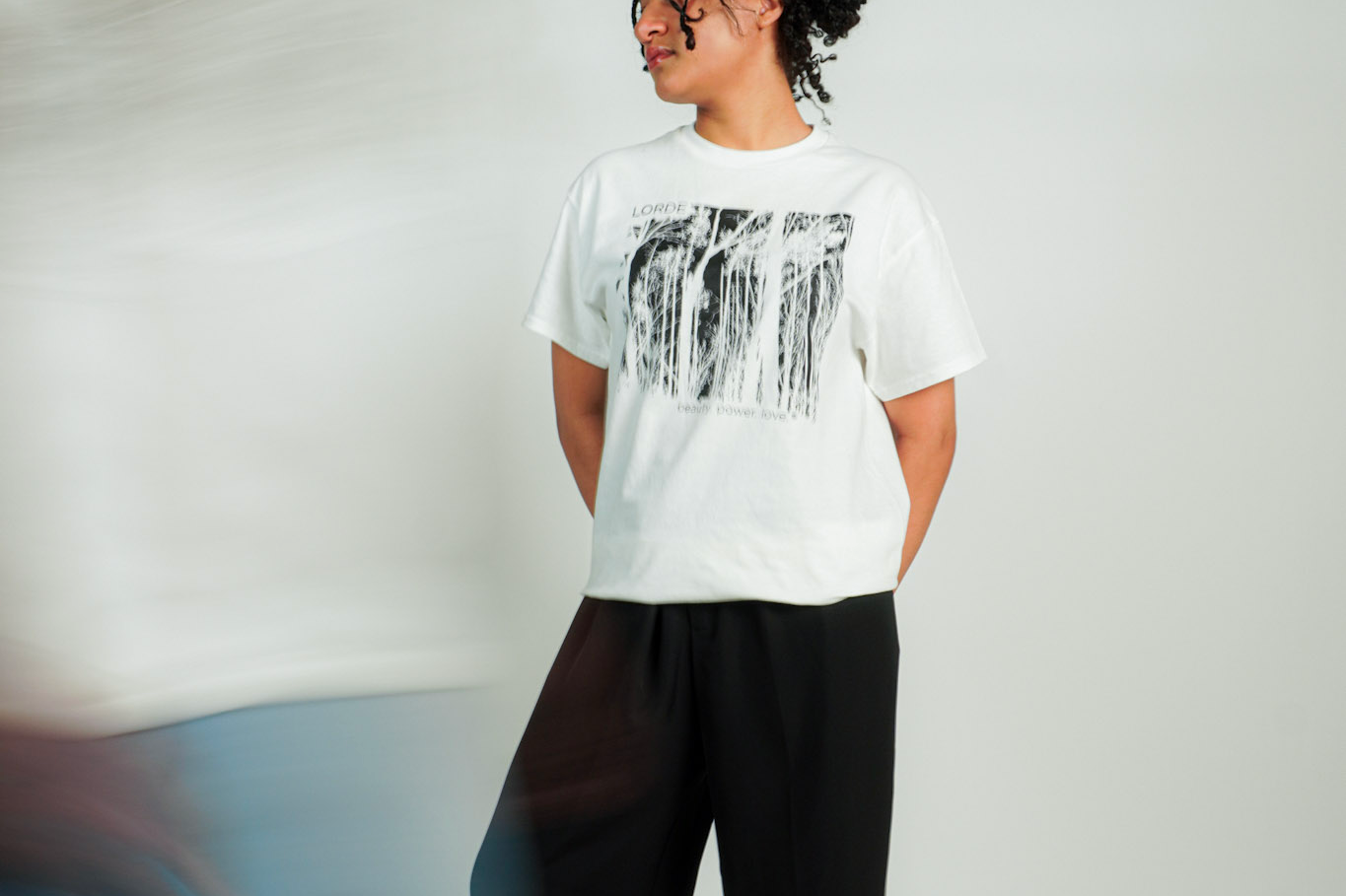 
  
  Person wearing LORDE Beauty Power Love Artist Designed Graphic T-Shirt
  
