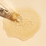 
  
  Close-up of a dropper with Ere Perez Guava Gradual Tan liquid on a beige background
  
