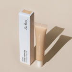 
  
  Ere Perez Lychee Creme Correctors Uno comes in a clear squeeze tube with a white screw-on top alongside its white box.
  
