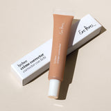 
  
  Ere Perez Lychee Creme Correctors Tres comes in a clear squeeze tube with a white screw-on top placed atop its white box.
  
